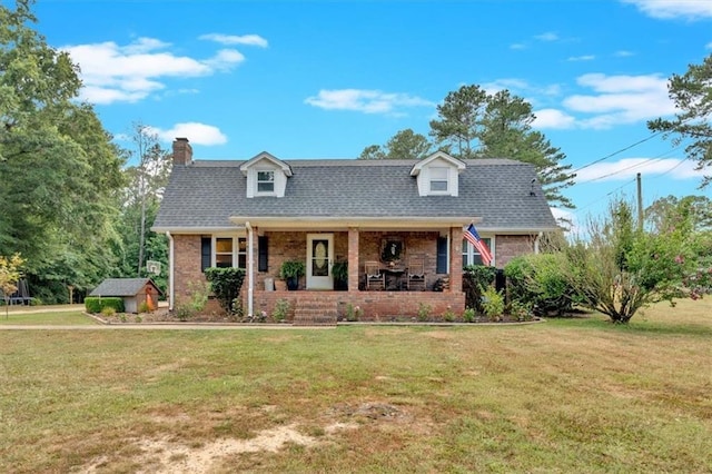 new england style home with a front lawn and a porch