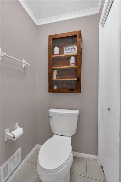 bathroom featuring toilet, tile patterned floors, and ornamental molding