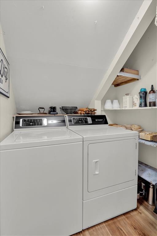 washroom featuring separate washer and dryer and light hardwood / wood-style flooring