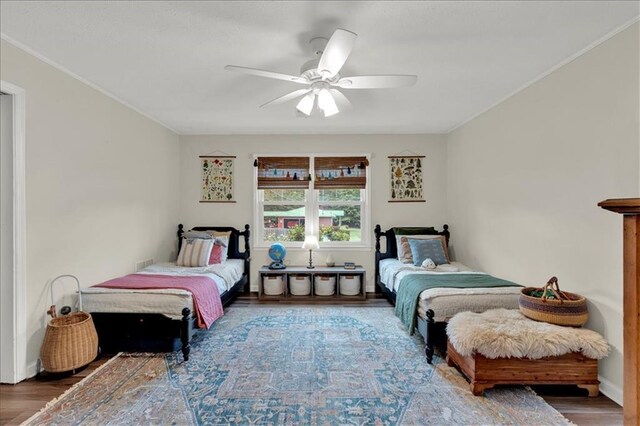 bedroom with ceiling fan and wood-type flooring