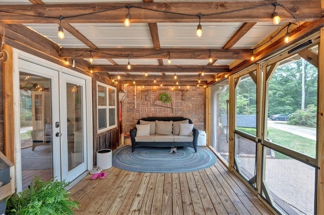 unfurnished sunroom featuring beam ceiling and french doors