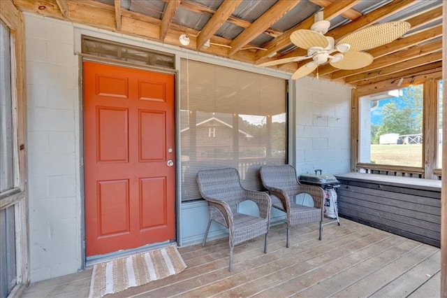 entrance to property featuring ceiling fan and a deck