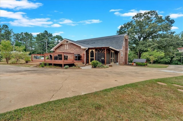 view of front facade with a front yard and a deck