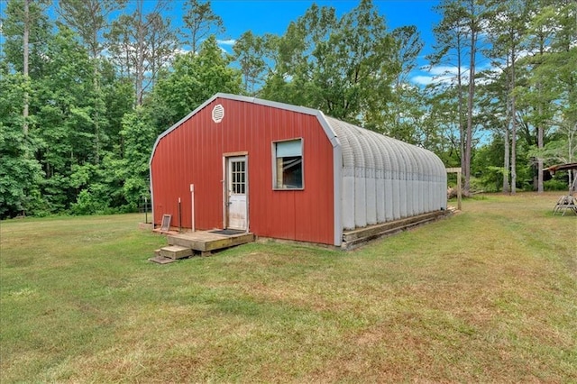 view of outbuilding featuring a lawn