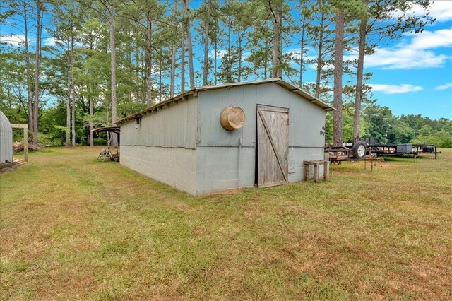 view of outdoor structure featuring a lawn