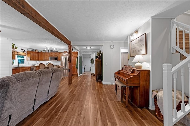 living room with hardwood / wood-style floors and a textured ceiling