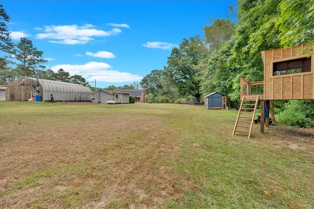 view of yard with a playground and a shed