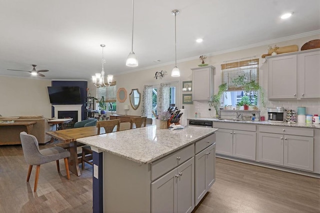 6721 Moondancer Ct, Flowery Branch, GA 30542 - kitchen featuring a ceiling fan, light wood-style flooring, tasteful backsplash, plenty of natural light, and ornamental molding