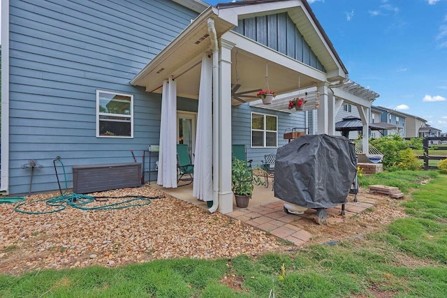 6721 Moondancer Ct, Flowery Branch, GA 30542 - view of side of property featuring board and batten siding, a ceiling fan, and a patio area