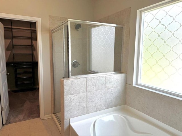 bathroom featuring tile patterned floors and independent shower and bath