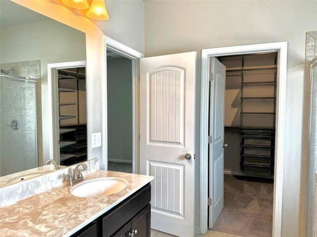 bathroom with tile patterned flooring, vanity, and a shower with shower door