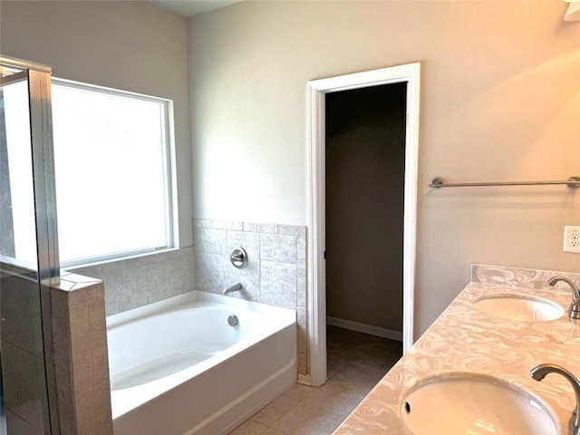 bathroom featuring tile patterned flooring, vanity, and plus walk in shower