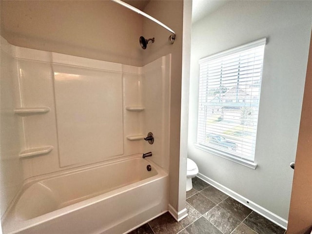 bathroom with shower / bathing tub combination and toilet