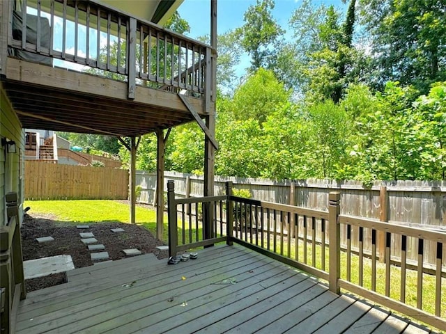 wooden deck featuring a yard