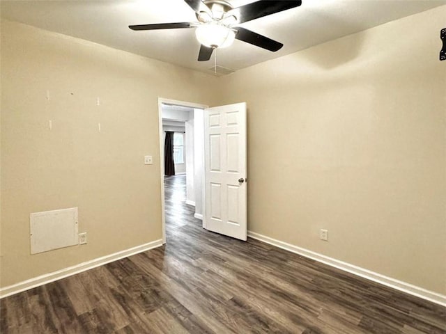 spare room with dark hardwood / wood-style floors and ceiling fan