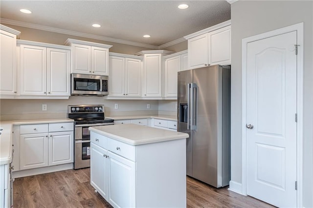 kitchen featuring appliances with stainless steel finishes, a center island, light hardwood / wood-style floors, and white cabinets