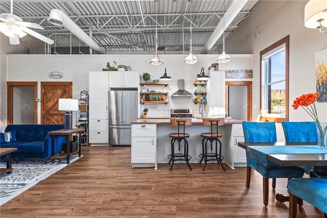 5097 Peachtree Rd Unit I, Atlanta, GA 30341 - kitchen featuring stainless steel appliances, wall chimney range hood, dark wood-type flooring, and ceiling fan