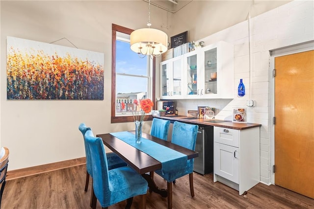 5097 Peachtree Rd Unit I, Atlanta, GA 30341 - dining room featuring dark wood-style floors, a chandelier, and baseboards