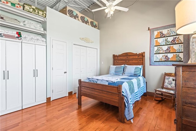 5097 Peachtree Rd Unit I, Atlanta, GA 30341 - bedroom with multiple closets, light wood finished floors, a towering ceiling, and a ceiling fan