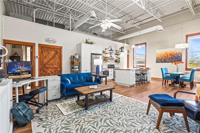 5097 Peachtree Rd Unit I, Atlanta, GA 30341 - living area featuring a high ceiling, ceiling fan, and light wood-type flooring