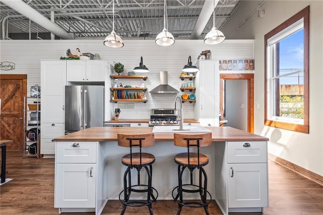 5097 Peachtree Rd Unit I, Atlanta, GA 30341 - kitchen with stainless steel appliances, wooden counters, wall chimney range hood, open shelves, and dark wood-type flooring