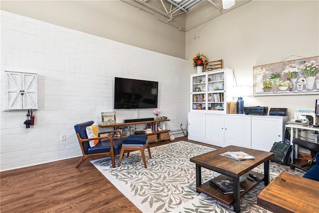 5097 Peachtree Rd Unit I, Atlanta, GA 30341 - living area featuring brick wall, wood finished floors, and a high ceiling