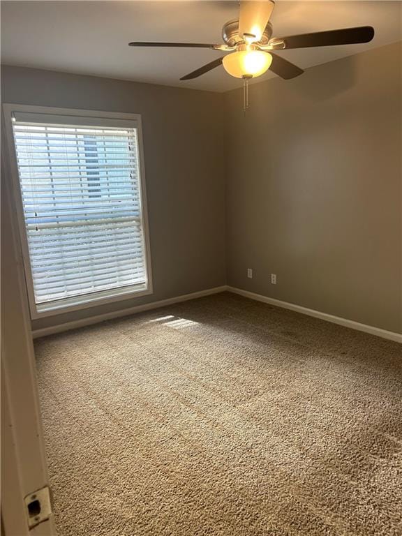 carpeted empty room featuring ceiling fan