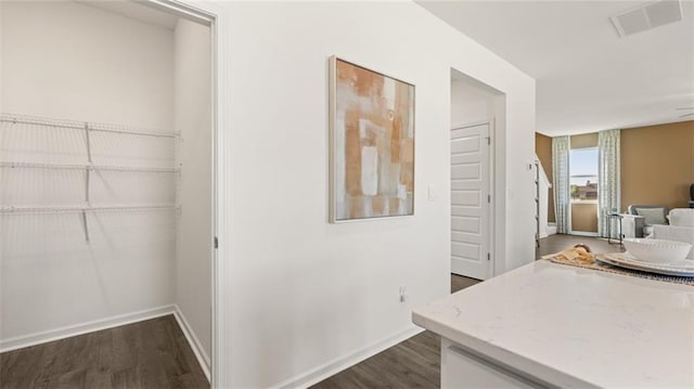 corridor with dark wood-type flooring