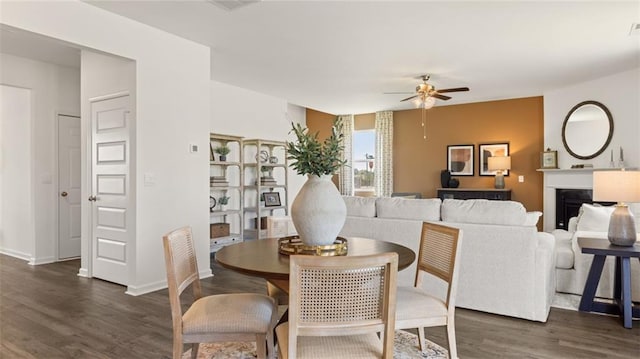 dining space with dark hardwood / wood-style floors and ceiling fan