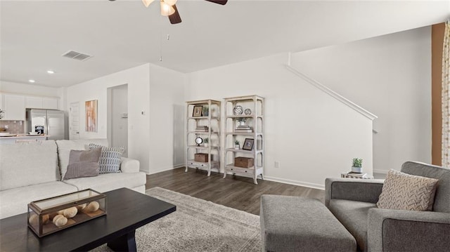 living room with dark wood-type flooring and ceiling fan