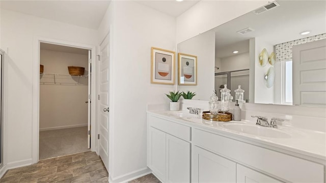 bathroom with vanity and a shower with shower door