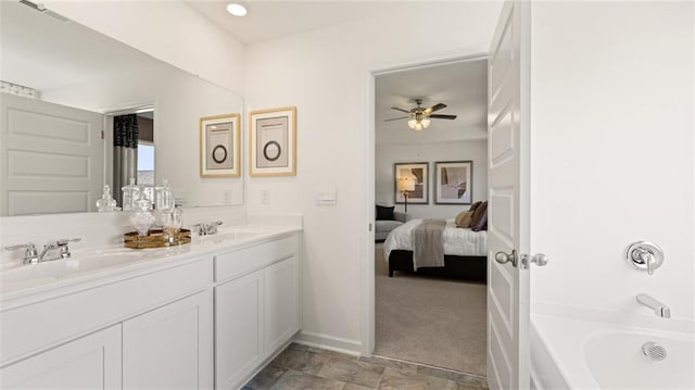 bathroom with vanity, a tub to relax in, and ceiling fan