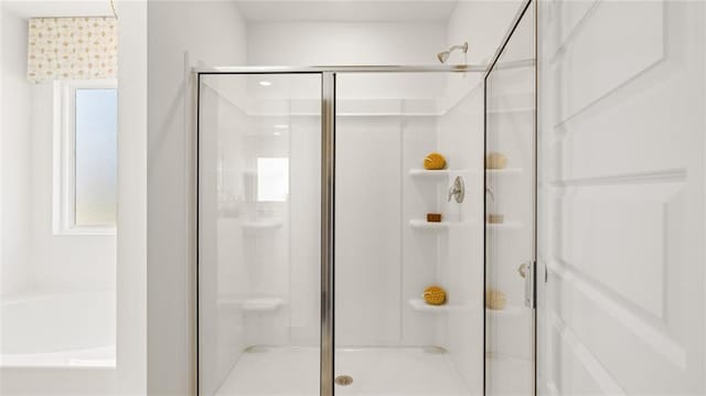 bathroom featuring shower with separate bathtub