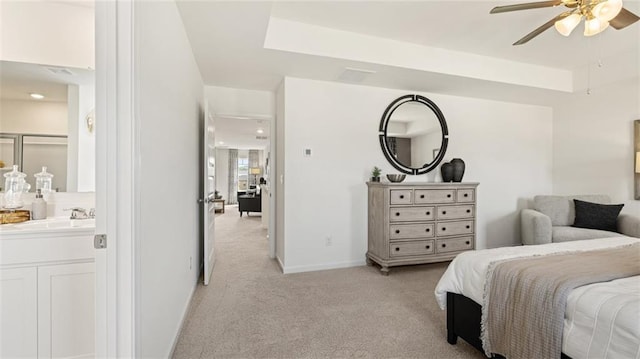 carpeted bedroom with ceiling fan and sink