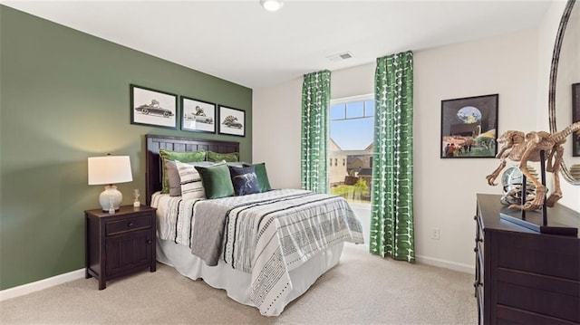 bedroom featuring light colored carpet