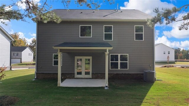 back of house with a patio and a lawn