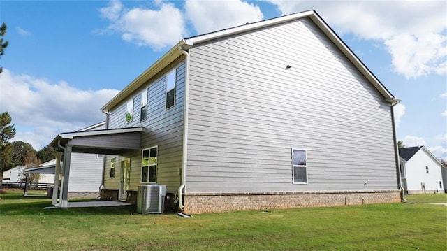 view of home's exterior with a patio area, central air condition unit, and a lawn