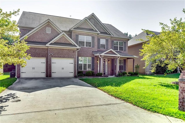 view of front of property featuring a front yard and a garage