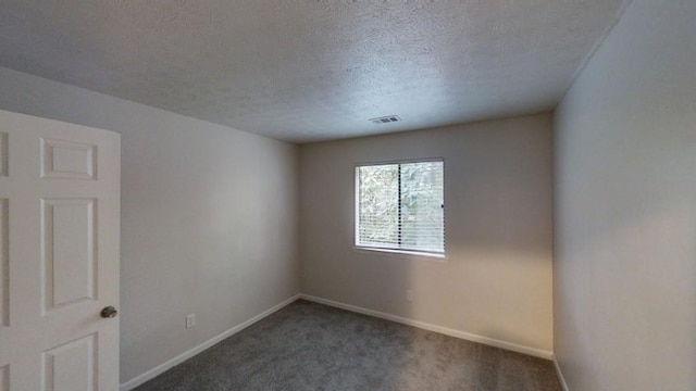 1169 Oaks Pl, Stone Mountain, GA 30083 - carpeted spare room featuring baseboards and a textured ceiling