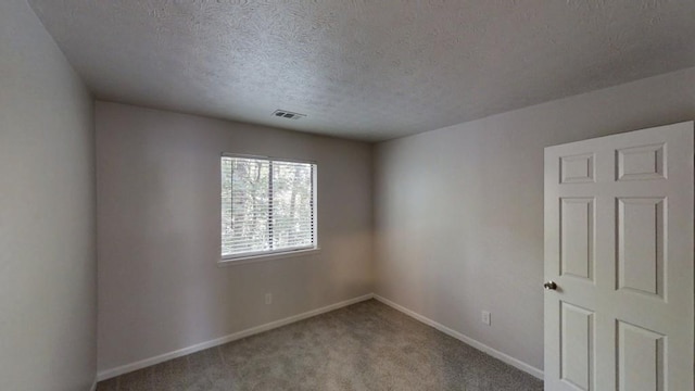 1169 Oaks Pl, Stone Mountain, GA 30083 - unfurnished room with a textured ceiling and carpet floors