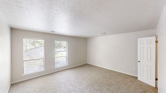 1169 Oaks Pl, Stone Mountain, GA 30083 - carpeted spare room with baseboards and a textured ceiling
