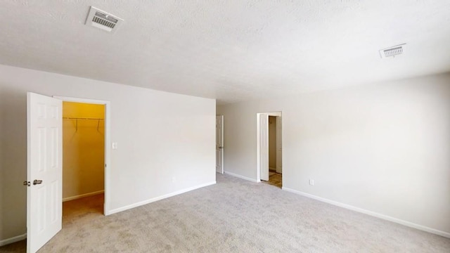 1169 Oaks Pl, Stone Mountain, GA 30083 - unfurnished room featuring light colored carpet and a textured ceiling