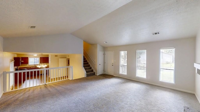 1169 Oaks Pl, Stone Mountain, GA 30083 - unfurnished living room with carpet and vaulted ceiling