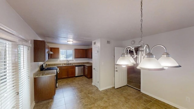 1169 Oaks Pl, Stone Mountain, GA 30083 - kitchen with stainless steel appliances, light countertops, brown cabinets, under cabinet range hood, and a chandelier