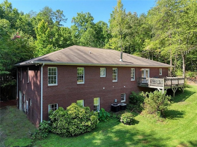 view of property exterior featuring a deck, cooling unit, and a lawn