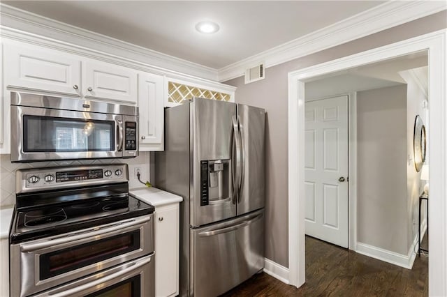 1634 Ponce De Leon Ave Unit 107, Atlanta, GA 30307 - kitchen featuring stainless steel appliances, light countertops, white cabinetry, decorative backsplash, and crown molding
