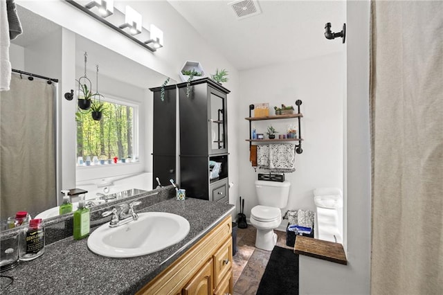 69 Due W Pass, Dallas, GA 30157 - full bathroom with vaulted ceiling, visible vents, vanity, and toilet