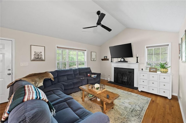 69 Due W Pass, Dallas, GA 30157 - living area with wood finished floors, a fireplace with flush hearth, ceiling fan, a healthy amount of sunlight, and lofted ceiling