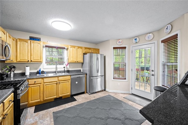 69 Due W Pass, Dallas, GA 30157 - kitchen with stainless steel appliances, a sink, a textured ceiling, and dark countertops