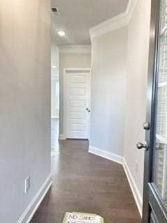 hallway featuring baseboards, dark wood-style flooring, and crown molding